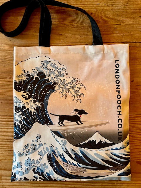 Humorous design Tote bag with the image of the Hokusai Wave plus a small dachshund on a surfboard.