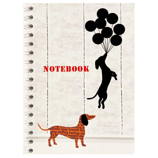 A6 notebook with a graffiti image of a Dachshund hanging onto floating balloons in Banksy style.