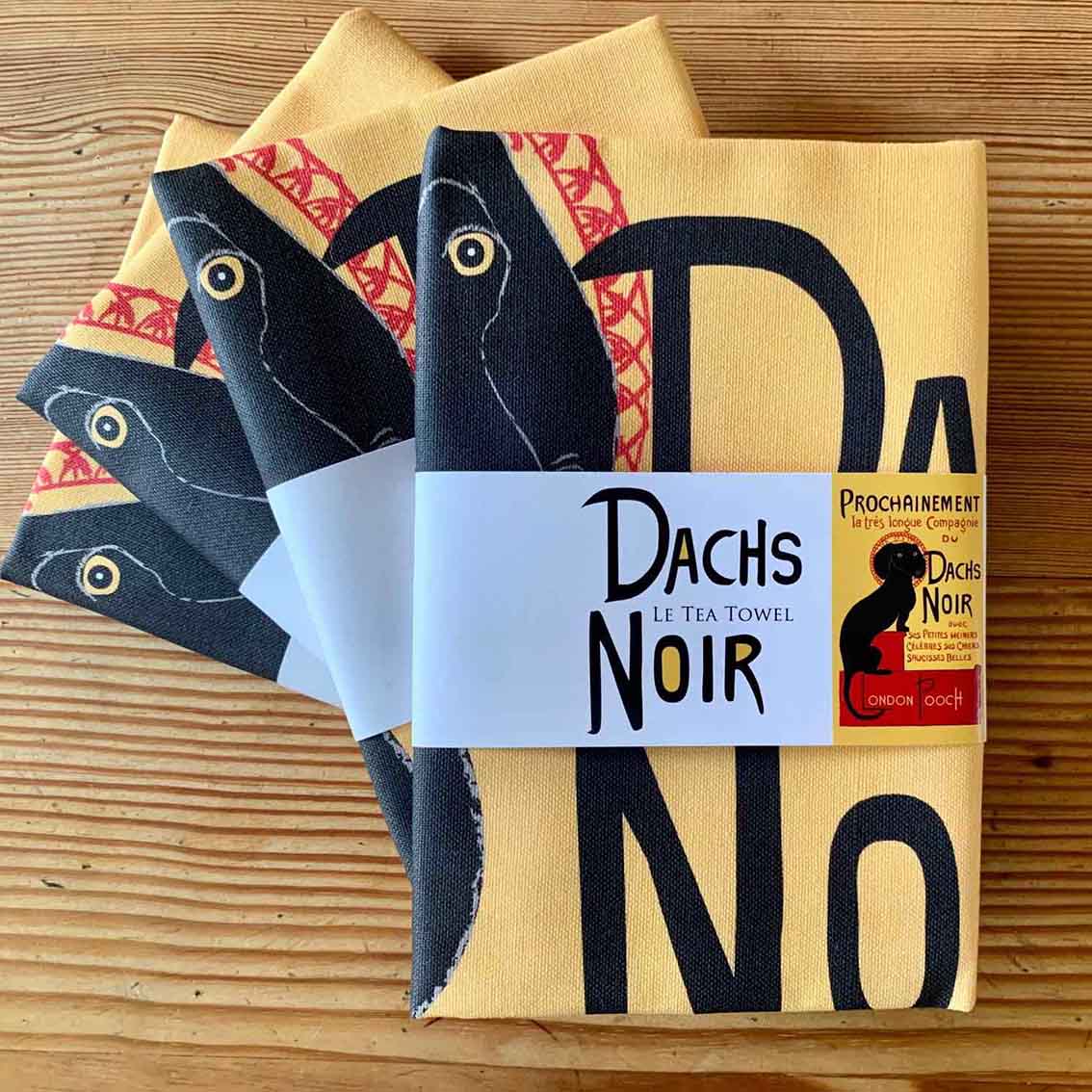 The Iconic French poster Chat Noir wittily redrawn in Dachshund style as the Dachs Noir and printed as a Tea Towel.